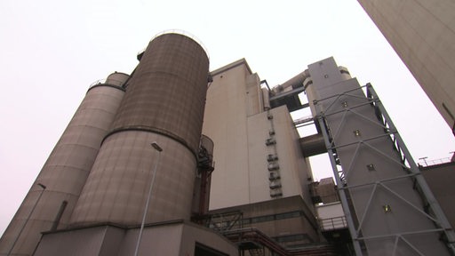 Ein graues Kohlekraft mit mehreren Gebäuden und Türmen.