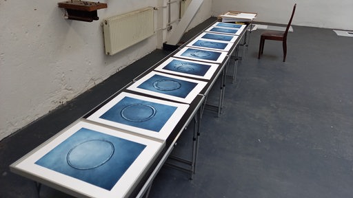 The blue pictures are next to each other on a table.