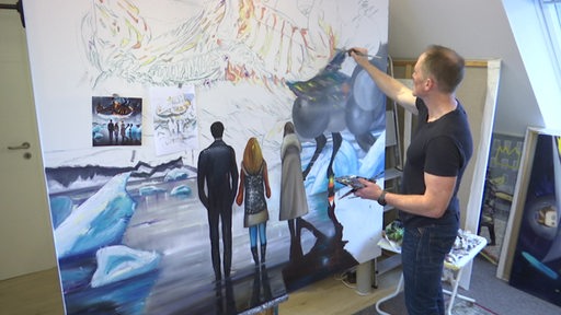 Zu sehen ist der Künstler Berend Bode beim Malen eines Bildes.