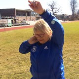 Die 87-jährige Leonide Baum hat eine Kugel an ihren Hals geklemmt und trägt einen Trainingsanzug