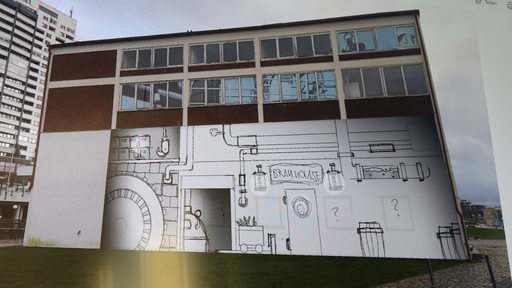 Auf einem Bildschirm ist ein Gebäude mit einer Zeichnung auf der Fassade zu sehen.