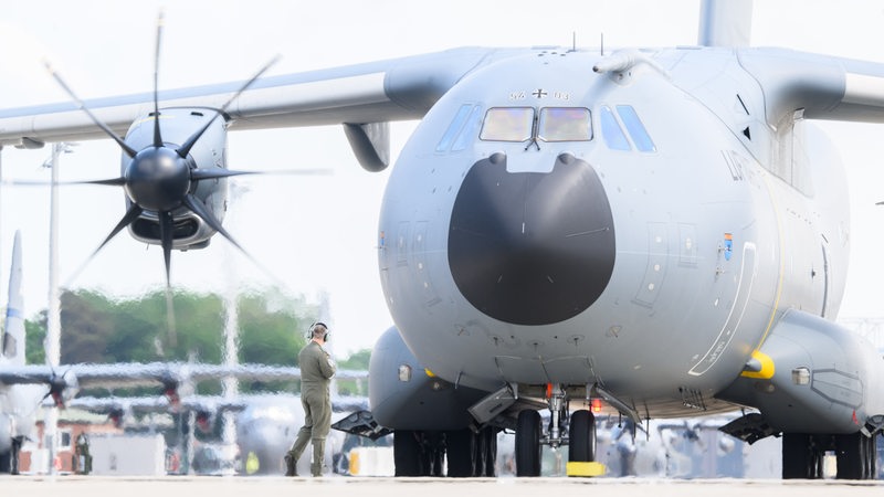 Ein Techniker steht vor einem Airbus A400M der Luftwaffe der Bundeswehr.