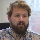 Ein Mann im Portrait, mit blonden Haaren udn Bart