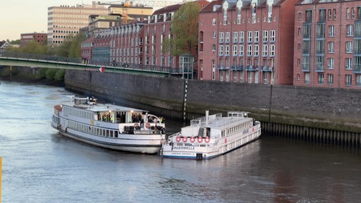 Zwei Schiffe auf einem Fluss berühren sich.