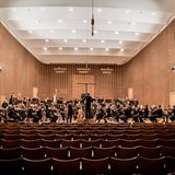 Musiker eines Symphonie-Orchesters stehen auf der Bühne des Sendesaals in Bremen