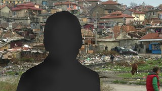Eine Silhouette eines Mannes vor heruntergekommenen Häuser und Müll in Varna in Bulgarien.