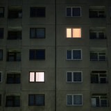 Licht brennt in einzelnen Wohnung eines mehrstöckigen Mehrfamilienhauses 