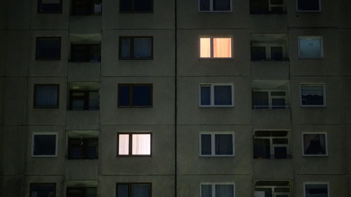 Licht brennt in einzelnen Wohnung eines mehrstöckigen Mehrfamilienhauses 