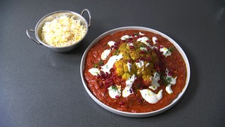 Zu sehen ist der Bremer Teller auf welchem Blumenkohl mit Tomatensauce und Safranreis serviert wird.