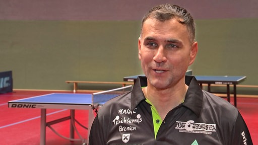 Werders Tischtennis-Coach Cristian Tamas bei einem TV-Interview in der Trainingshalle.