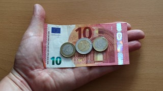 14 Euro liegen in einer offenen Hand.