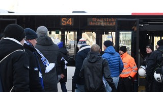 Polizeikräfte überwachen die Abfahrt der am Bahnhof ankommenden HSV Fans, die mit Bussen ins Stadion gebracht werden. 