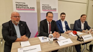 Jan Timke (zweiter von links) sitzt auf einem Podium neben anderen Menschen. Er führt die neue Fraktion von Bündnis Deutschland in der Bremischen Bürgerschaft an.