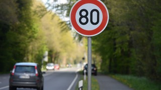 Ein 80er-Schild steht am Fahrbahnrand einer Landstraße